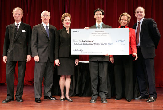 Michael Viscardi on stage receiving check at New York University